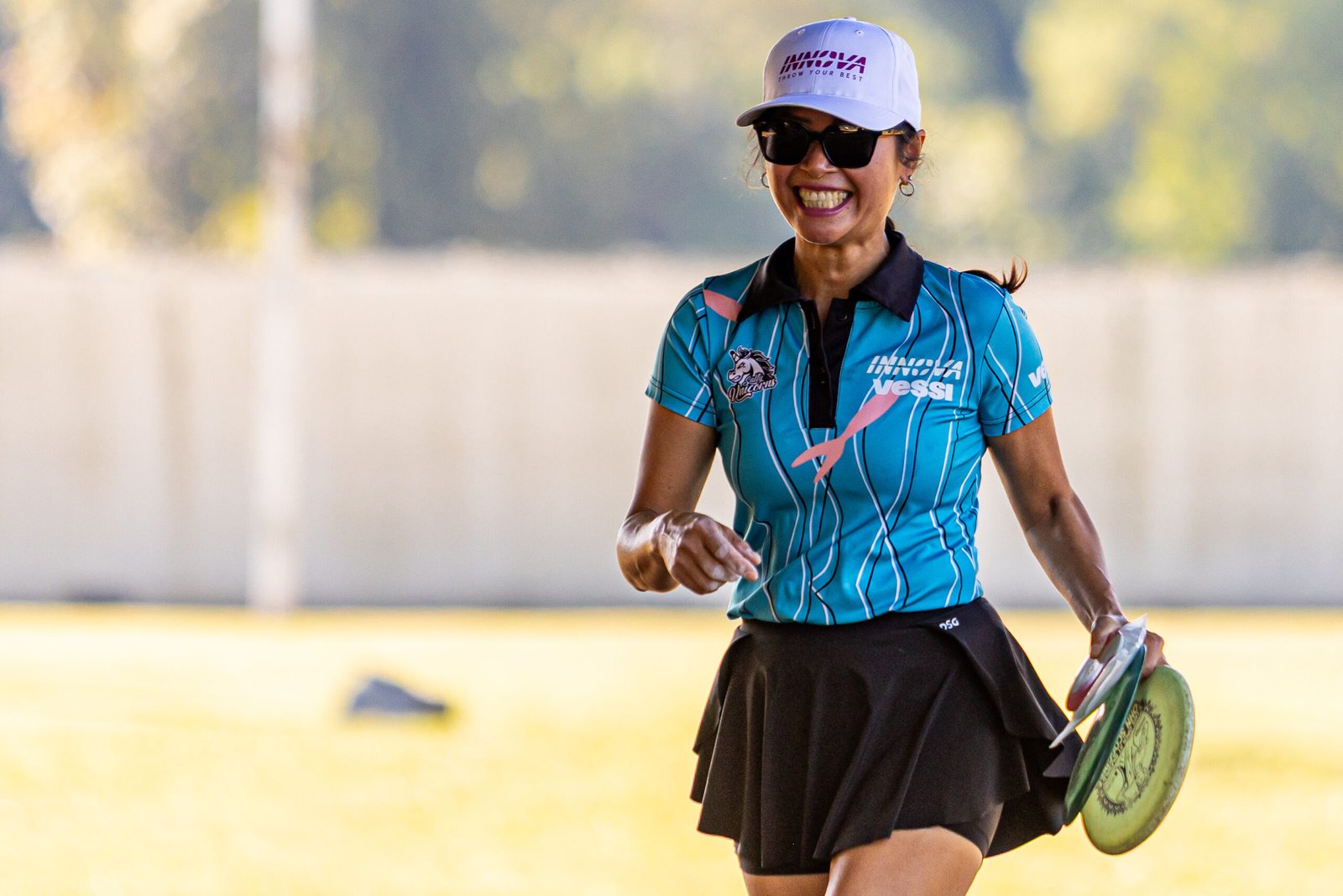 Ohn Scoggins smiles while carrying her discs at Winthrop during the opening round of Throw Pink.