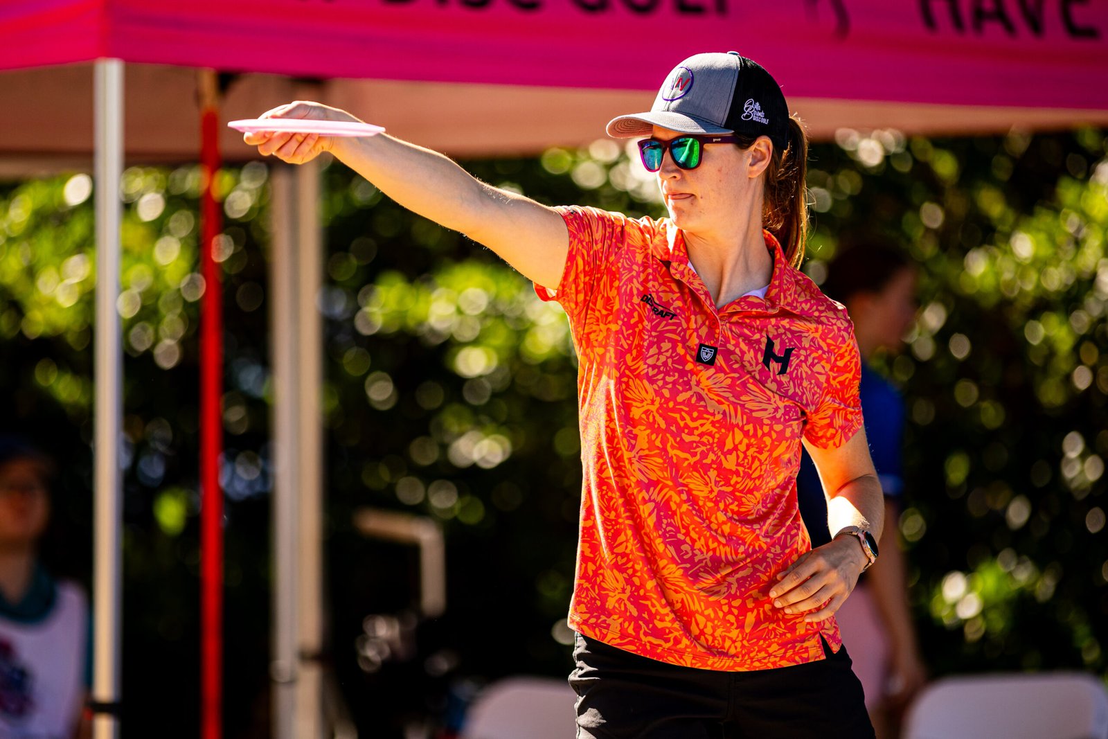 Holyn Handley lines up a shot beneath a pink canopy during the first round of Throw Pink.