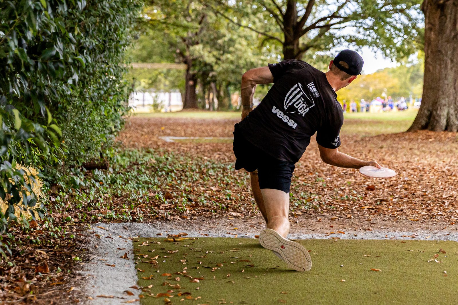 A USDGC competitor throws from the wooded tee on Hole 15 at Winthrop during round one.